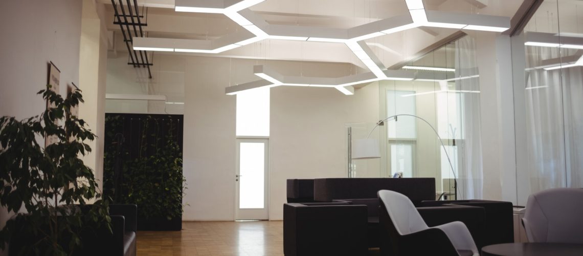View of empty modern office with sofa, table, chair